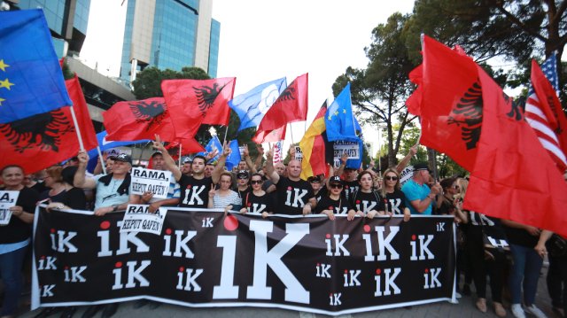 Protesters with "go" posters and T-shirts|640x359